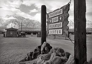 Black and white photo of the entrance sign at Manzanar War Relocation Center