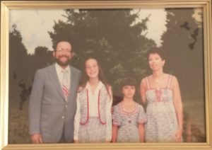 A very faded vintage-1970s photo of my family - father, sister, mother, and me - all dressed in matching outfits as described in the text.