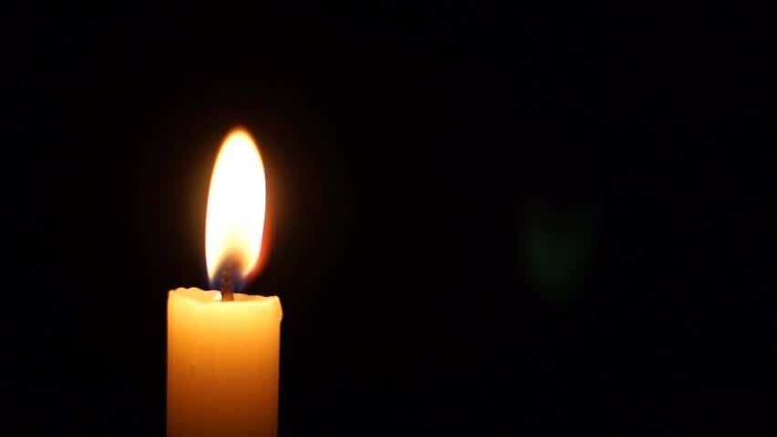 picture of a single lit candle against a dark background